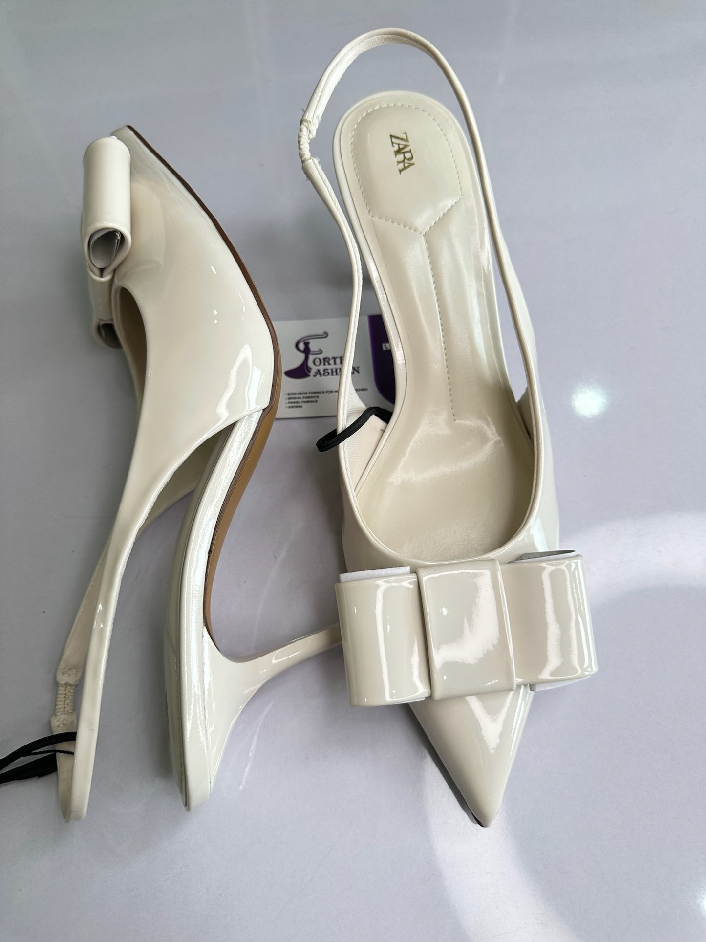 IVORY FAUX PATENT SLINGBACK HEELS WITH BOW